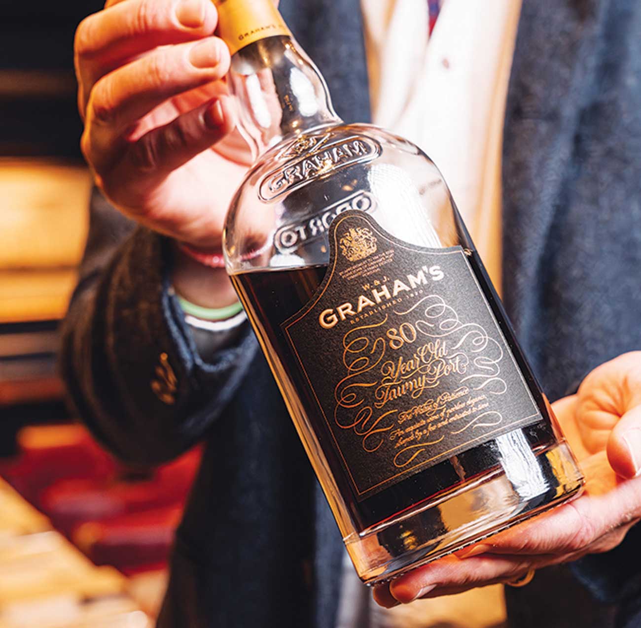 Hands holding bottle of Graham&amp;rsquo;s 80 Year Old Tawny