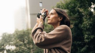 Photographer using the OM System OM-3 in an outdoor environment