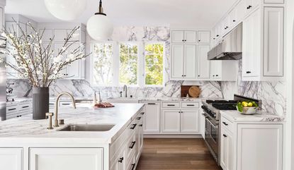 a white kitchen with bold marble veining