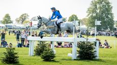 Dani Stewart-Richardson (n&eacute;e Evans) and Smart Time jump a cross-country fence made of white rails at Badminton 2018.