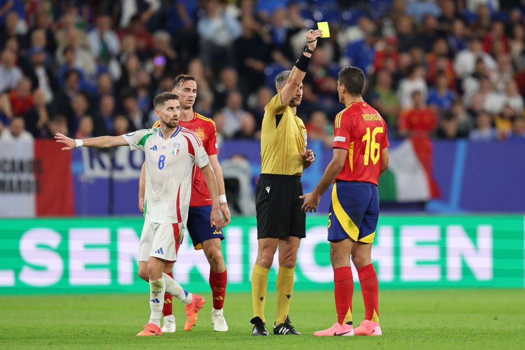 Referee Slavko Vincic shows Rodri of Spain a yellow card during the UEFA EURO 2024 group stage match between Spain and Italy at Arena AufSchalke on June 20, 2024 in Gelsenkirchen, Germany. (Photo by Matt McNulty - UEFA/UEFA via Getty Images) Albania Euro 2024