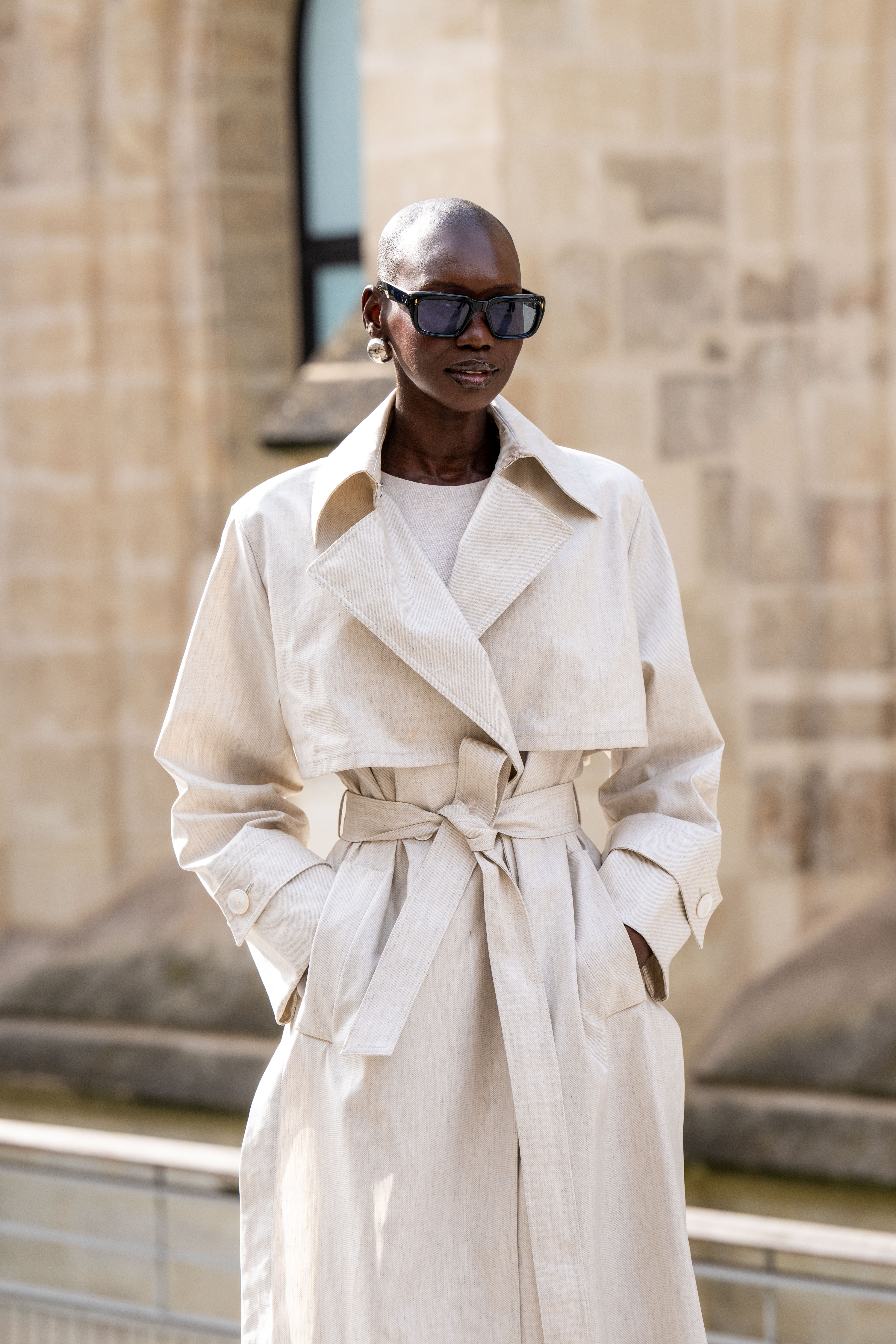 adot gak wears a trench coat and sunglasses