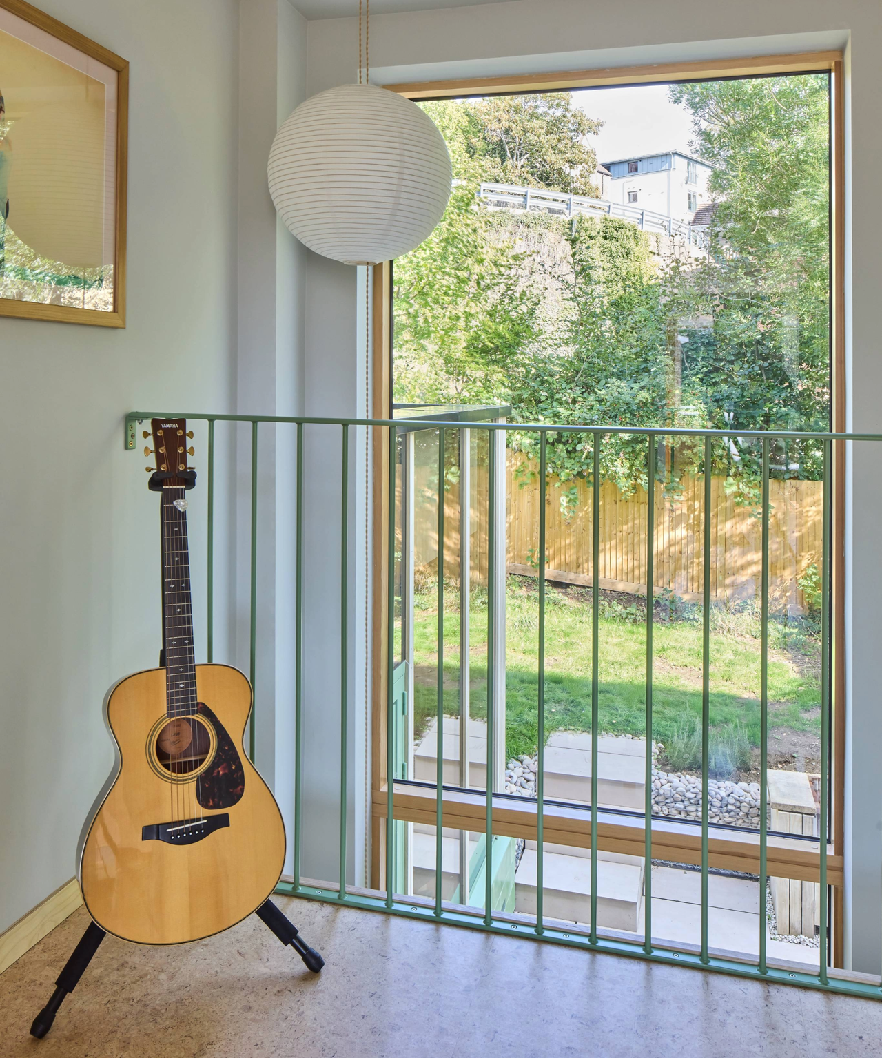 Top of the staircase which overlooks a large window facing the garden