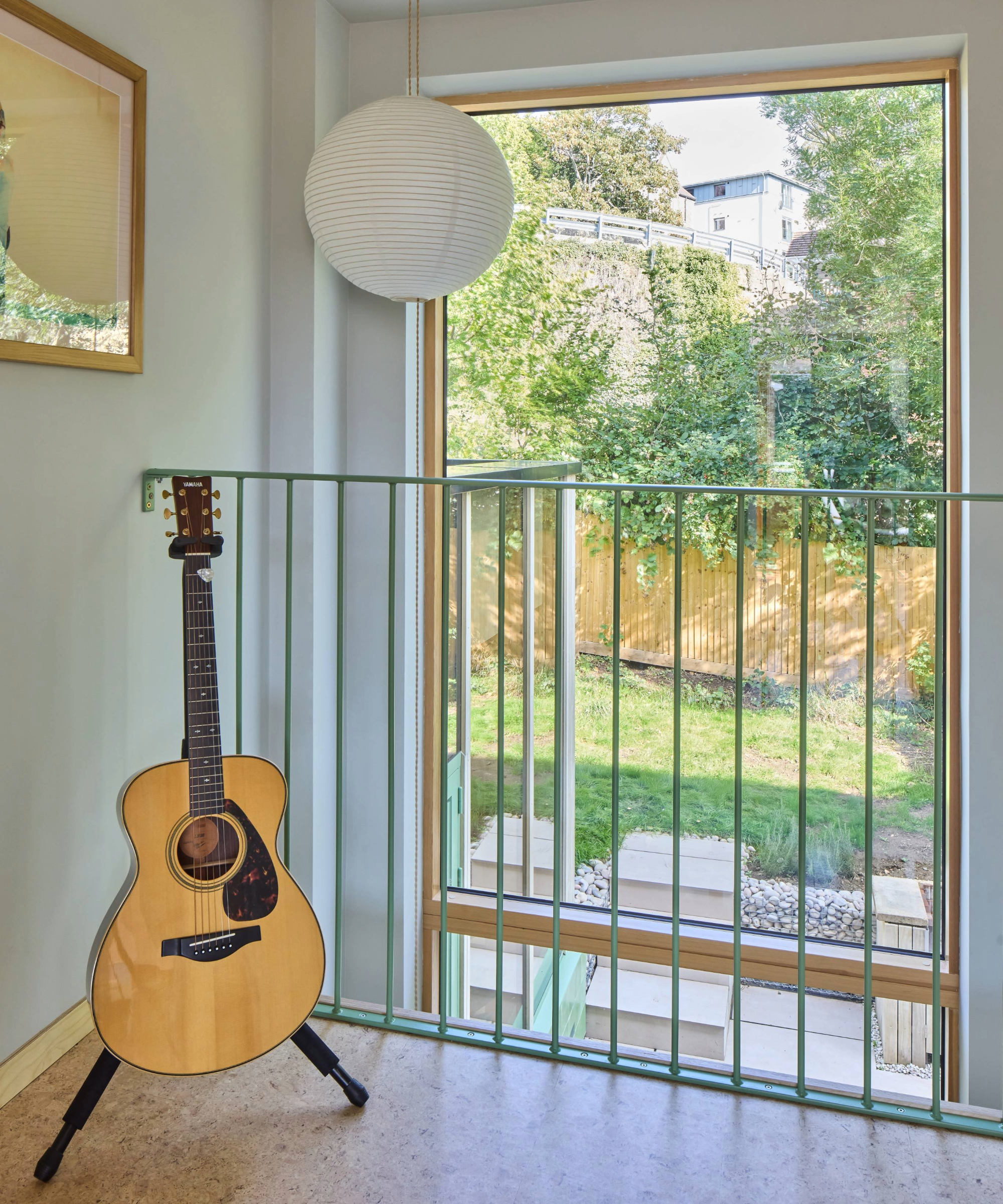 Top of the staircase which overlooks a large window facing the garden