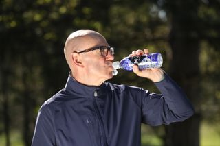 Golfer taking a sip of Max Golf Protein Hydration drink
