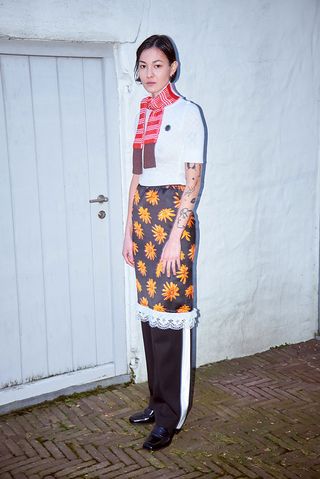 Meryll Rogge A/W 2021 model wears tuxedo trousers and daisy print skirt