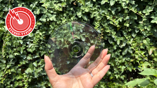 Lorde transparent CD held in hand with red Stereo-typing logo in corner