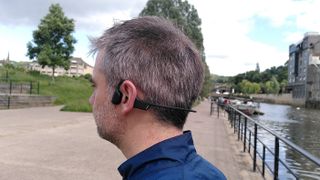 The reviewer wearing the Suunto Sonic headphones by the River Avon in Bath.