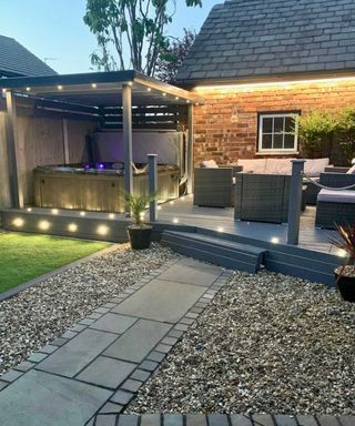 hot tub from hydrolife on raised deck with lit-up pergola