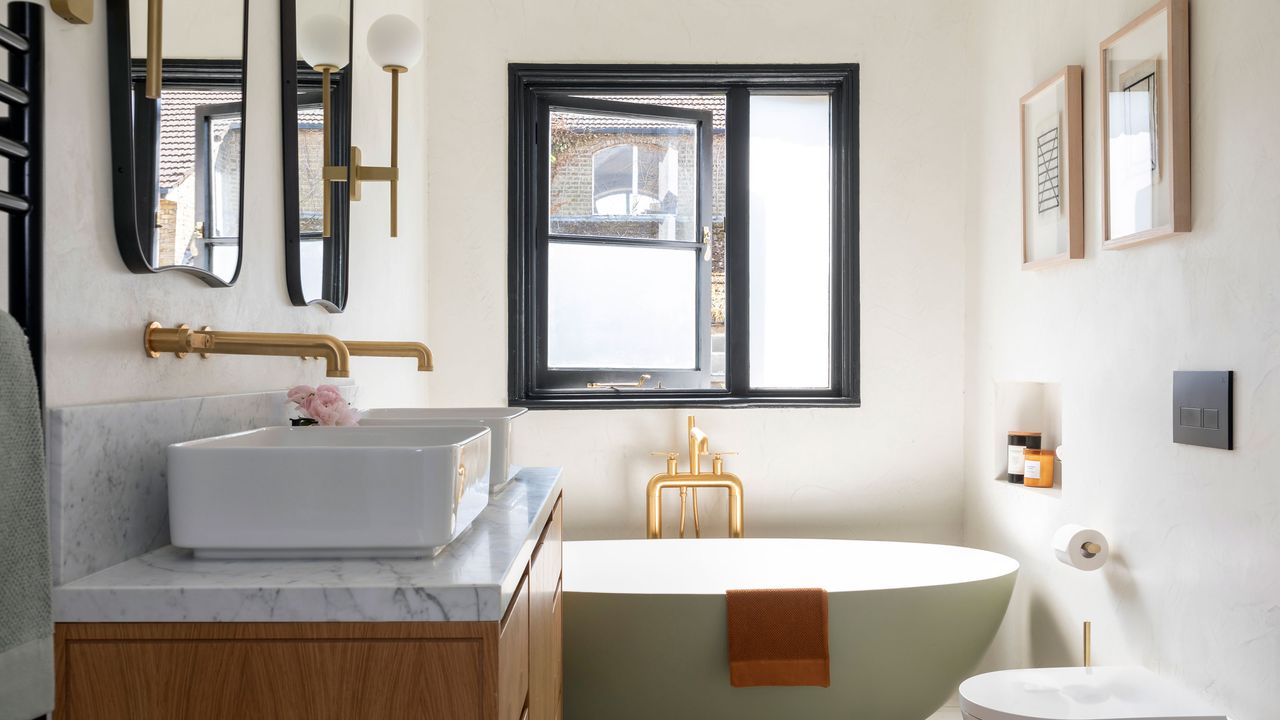 modern bathroom with green tub, gold shower and double sink