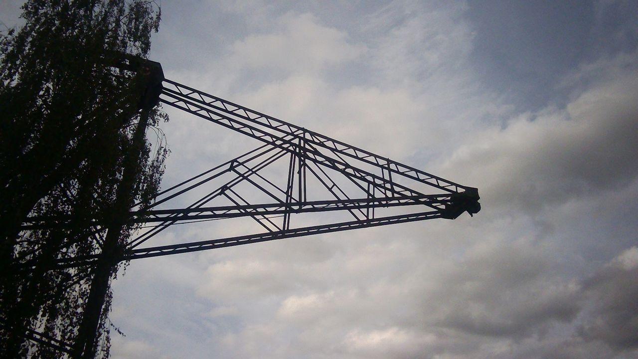 Sample photograph taken with Godox C100 showing old docking infrastructure silhouetted against the sky