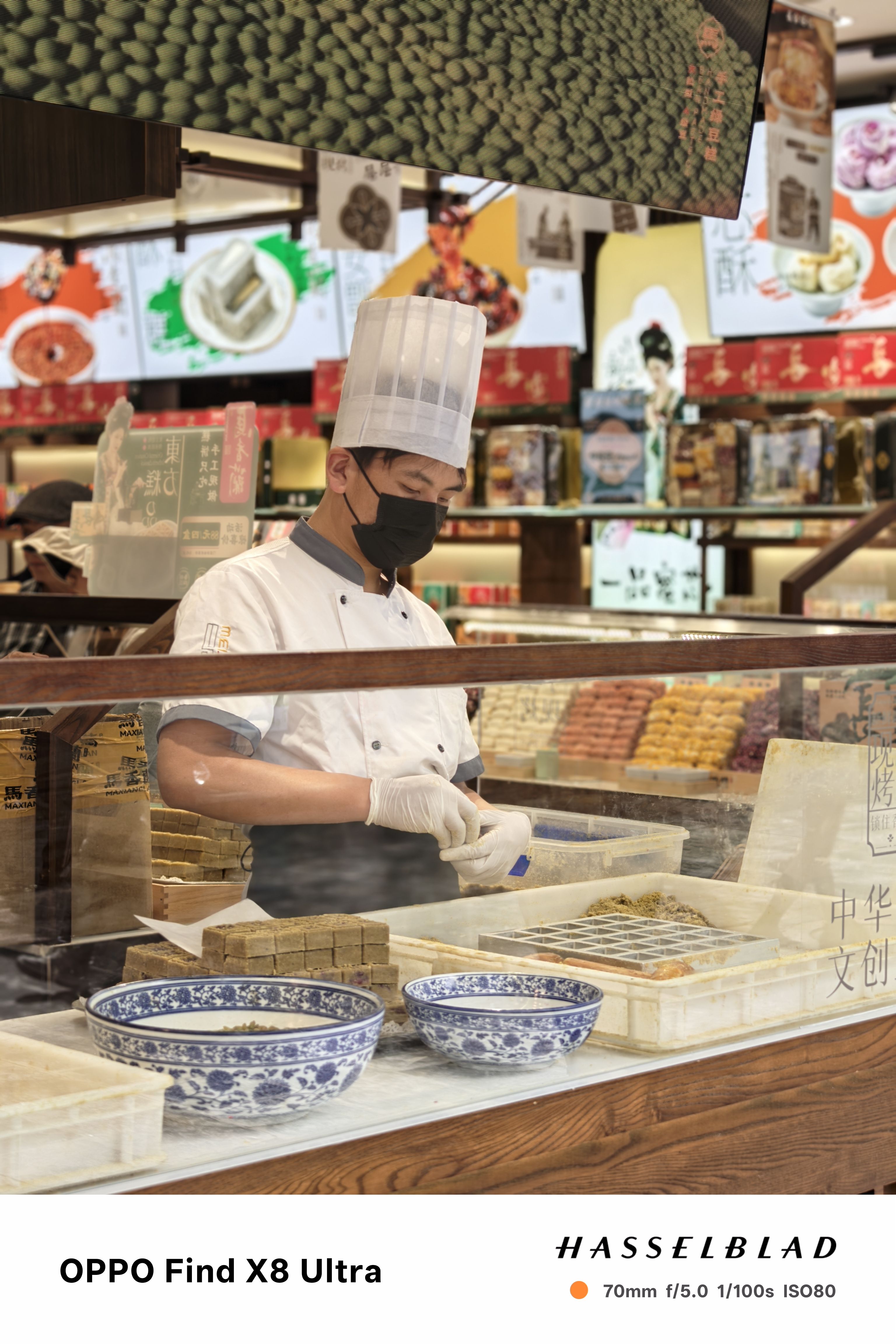 A person making traditional sweets in a market in China