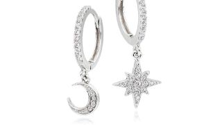 A pair of silver moon and star earrings from Beaverbrooks on a white background.