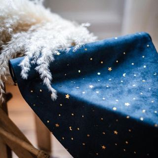 Moon & Stars Navy table runner on a table with dried flowers