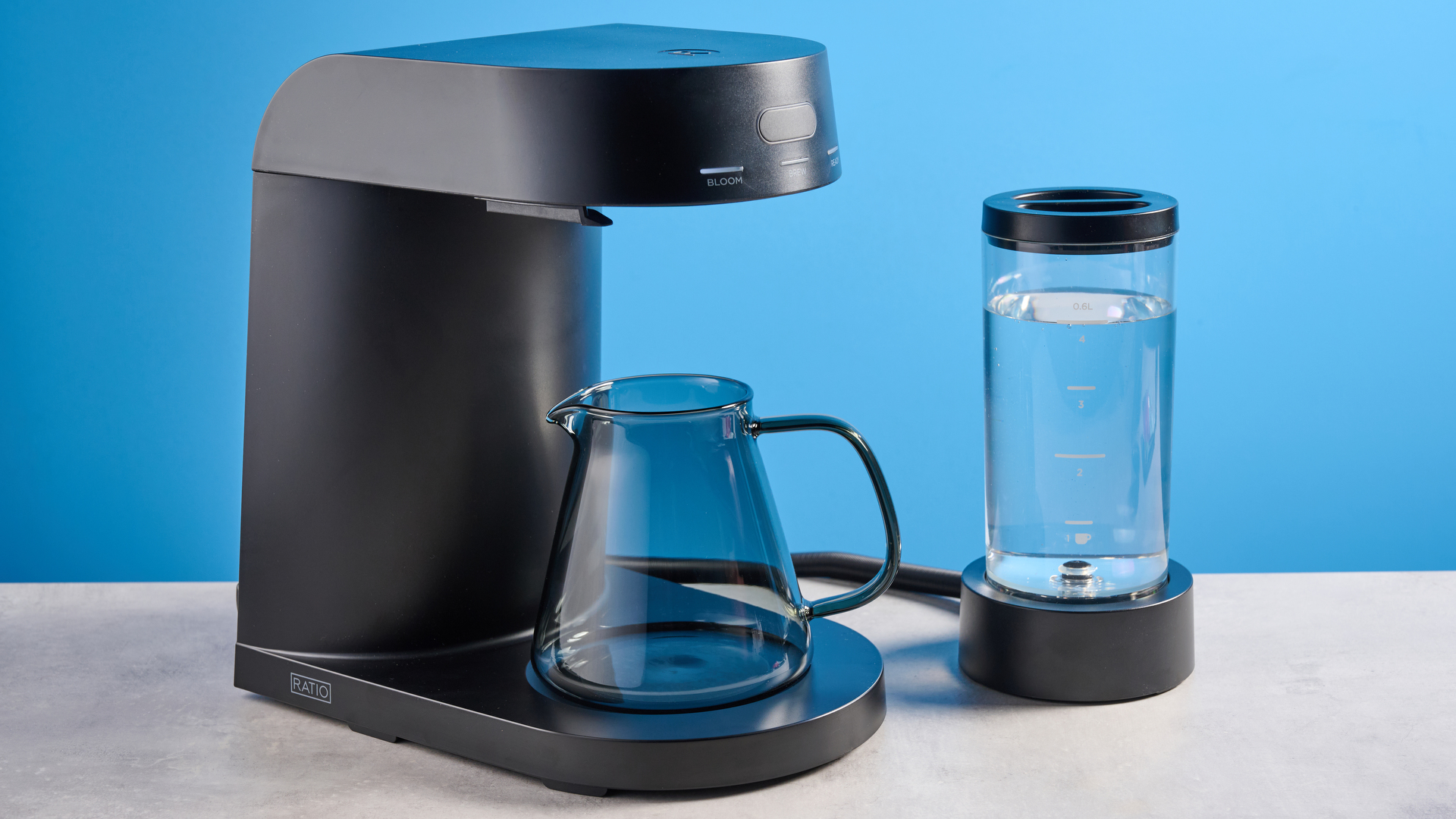 the ratio four coffee maker photographed against a blue tom's guide background