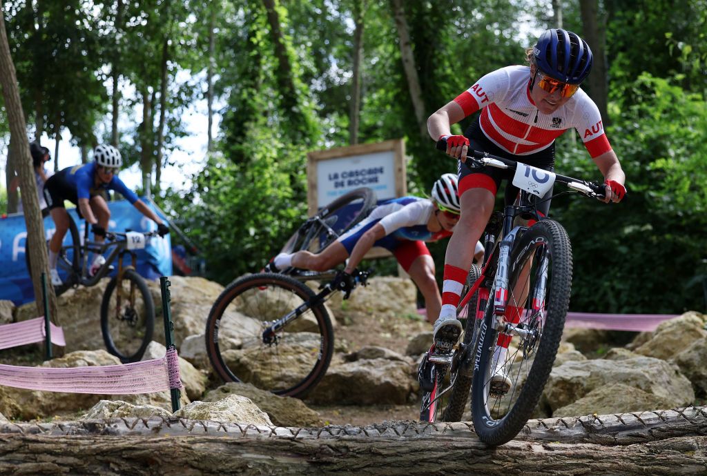 ELANCOURT FRANCE JULY 28 Loana Lecomte of Team France obscured crashes L while Laura Stigger of Team Austria R competes during the Womens CrossCountry Cycling Mountain Bike Gold Medal race on day two of the Olympic Games Paris 2024 at Elancourt Hill on July 28 2024 in Elancourt France Photo by Alex BroadwayGetty Images