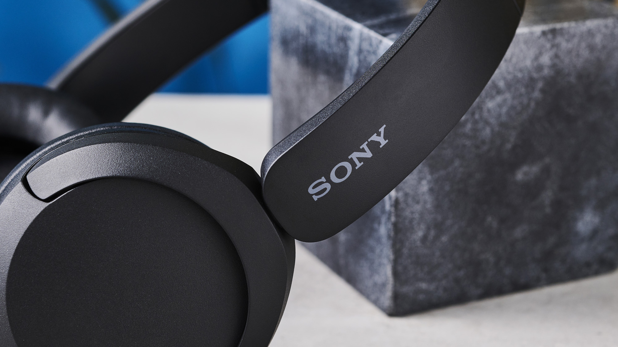 A photo of the Sony WH-CH520 over ear headphones resting against a black marble block