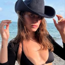 Hailey Bieber posing on the beach.