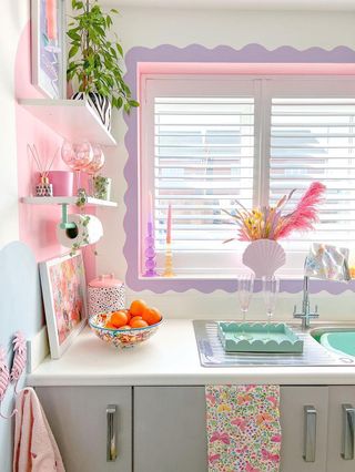 A colorful kitchen sink area with shelving