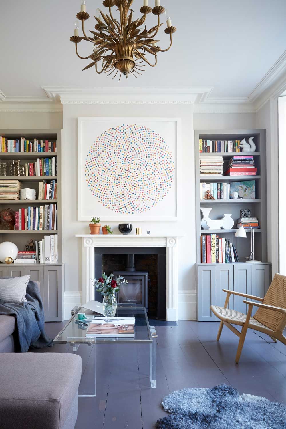 Elegant grey and white living room with log burner and built in bookcases