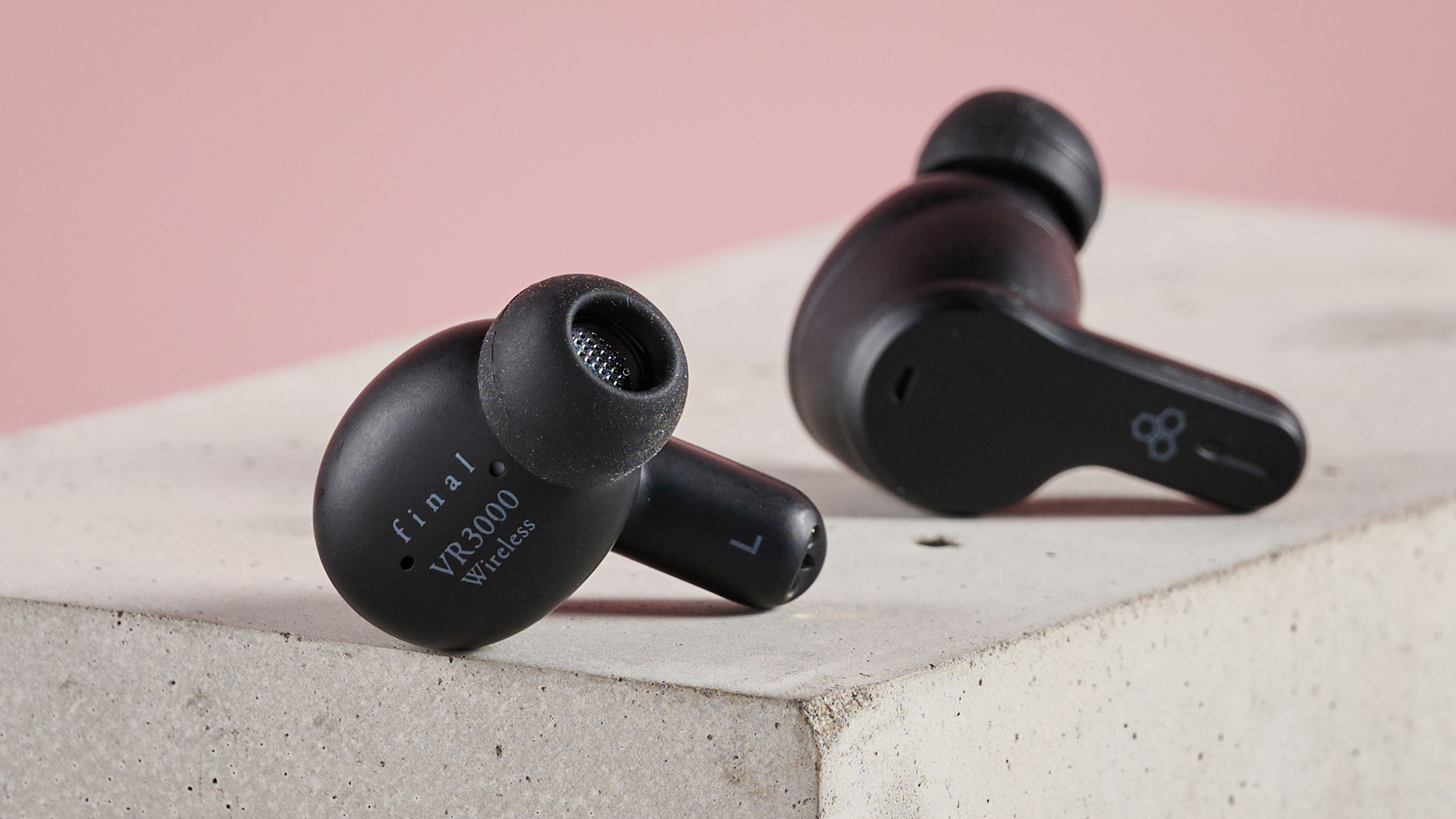 Final VR3000 Wireless earbuds on plinth with pink background