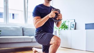 a photo of a man doing a kettlebell lunge