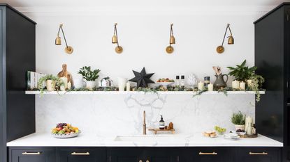 Navy kitchen with white marble and gold lighting