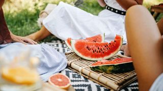 The best foods to eat in a heatwave - watermelon on a picnic blanket
