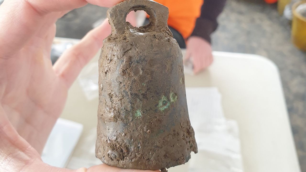A metal bell, probably used in religious ceremonies.