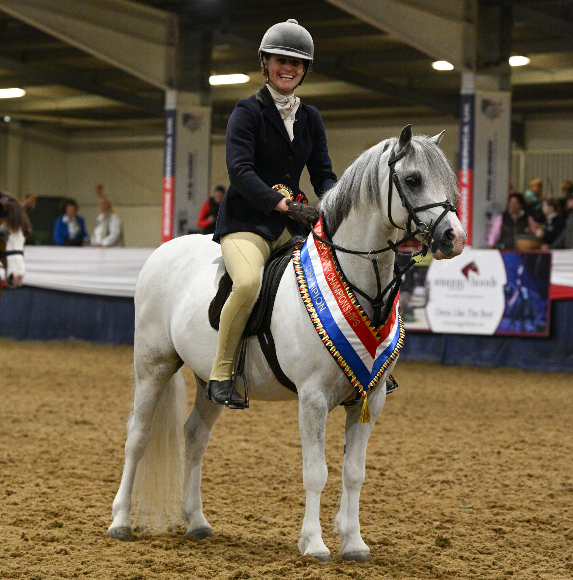 Tromps Sugar Rush and Samantha Roberts stand and smile for the camera with their sash after they stand novice and challenge heritage working hunter pony champions