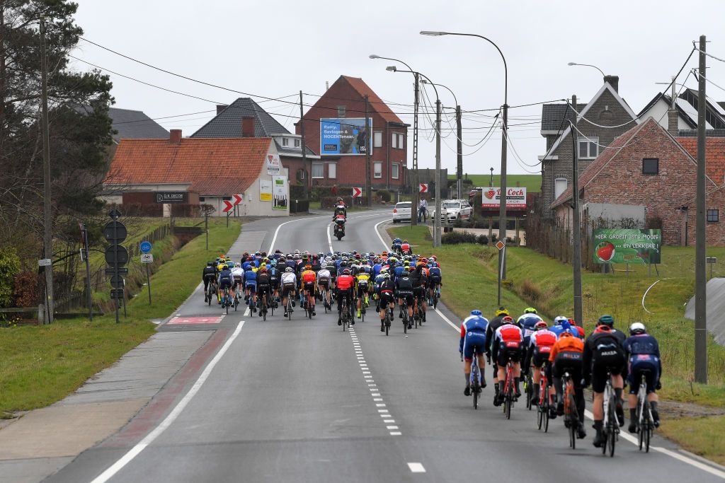 NOKERE BELGIUM MARCH 17 The peloton during the 75th Nokere Koerse Danilith Classic 2021 Mens Elite a 1955km race from Deinze to Nokere Village Landscape NokereKoerse on March 17 2021 in Nokere Belgium Photo by Luc ClaessenGetty Images