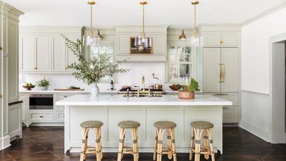 Classic kitchen cabinets in a luxury kitchen with island and bar chairs