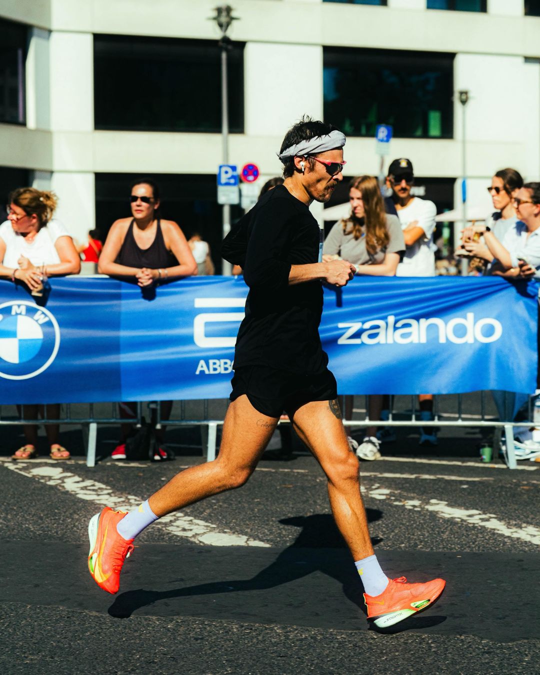 Harry Styles running Berlin Marathon in a mixture of Nike, Sums, Tracksmith, and District Vision race day kit