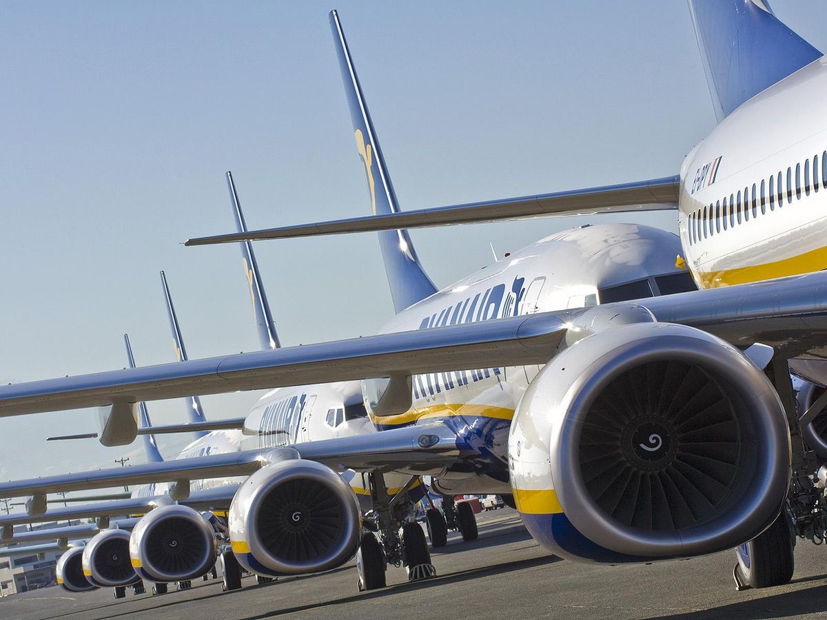 A line of aircraft waiting to taxi to the runway.