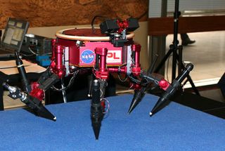 JPL's Limbed Excursion Mechanical Utility Robot (LEMUR). Robot is designed to walk autonomously and via remote control outside of space craft. It will be able to perform minor repairs. A camera is mounted on a rotating track, allowing it to see in all