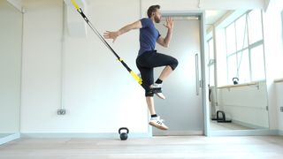 Niko Algieri demonstrates one position of the TRX burpee