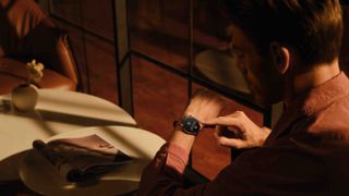 Person interacting with the Amazfit GTR 3 Pro watch in a cafe