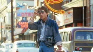 Michael J Fox as Marty McFly walking across the street in a scene from the film Back to the Future