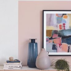 Living room with photo frame and pink paint surrounding it