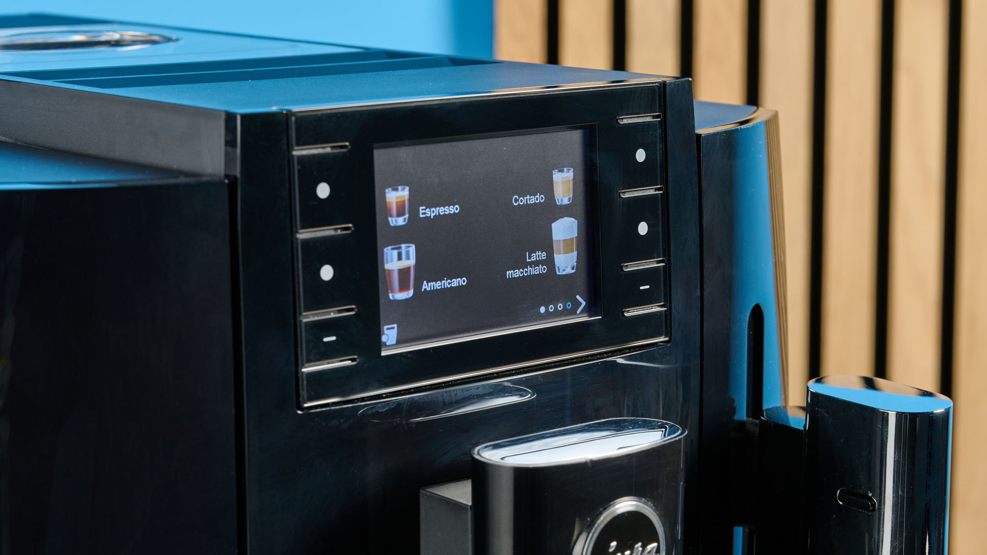 the jura E8 automatic coffee machine in piano black with a 64 ounce water tank, screen, and jura logo on the front