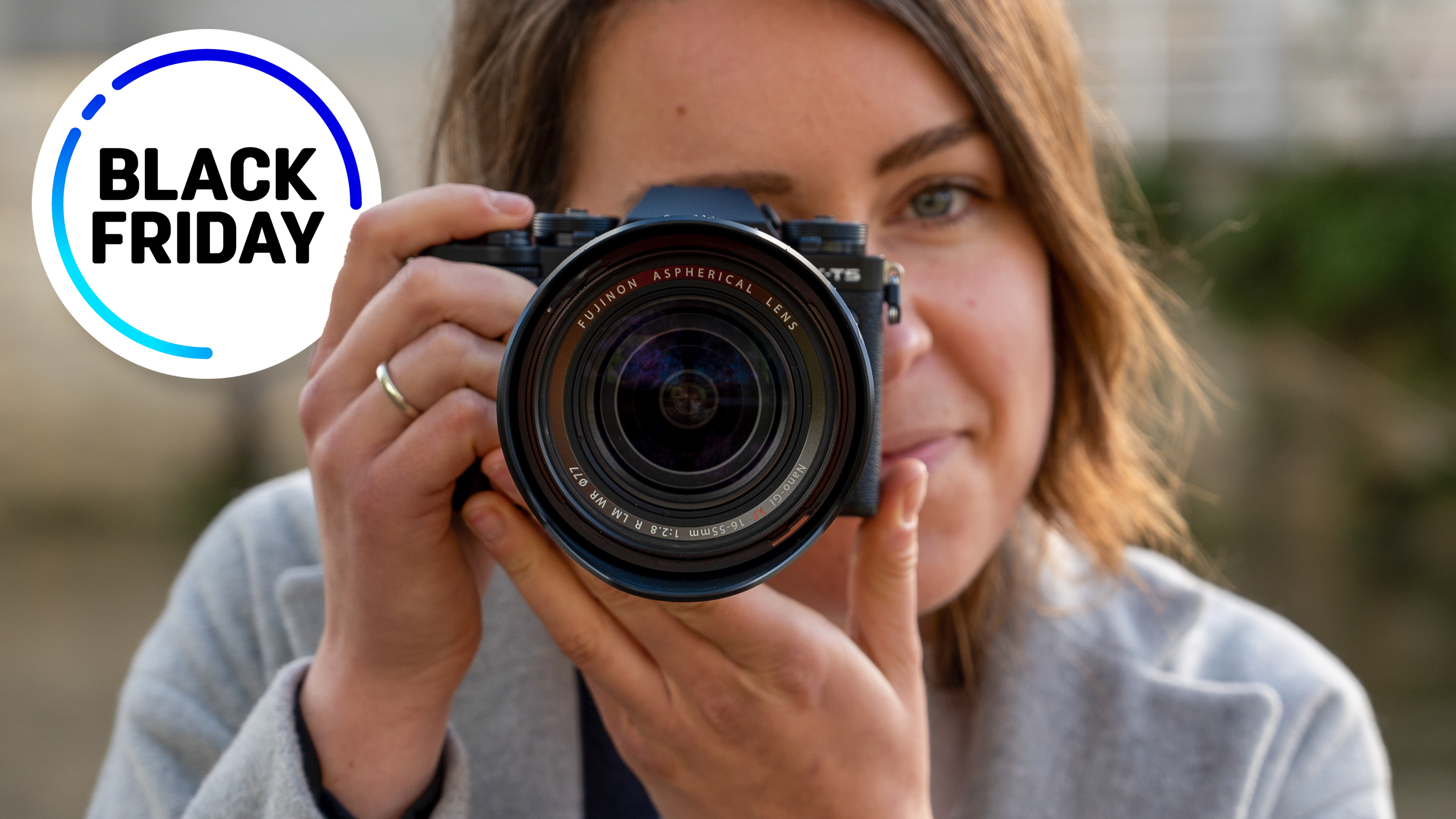 The Fujifilm X-T5 in a photographer&#039;s hands with the words &quot;Black Friday&quot;