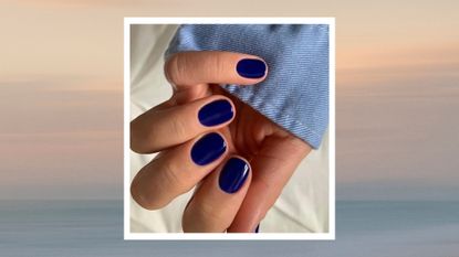 A hand with squoval royal blue nails by nail artist @gel.bymegan/ in a beige and blue sunset-like template