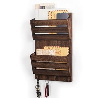 A wooden mail cubby organizre with two slots, four hooks along the bottom for hanging keys