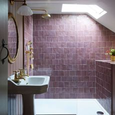 bathroom with purple tiled walls and white washbasin