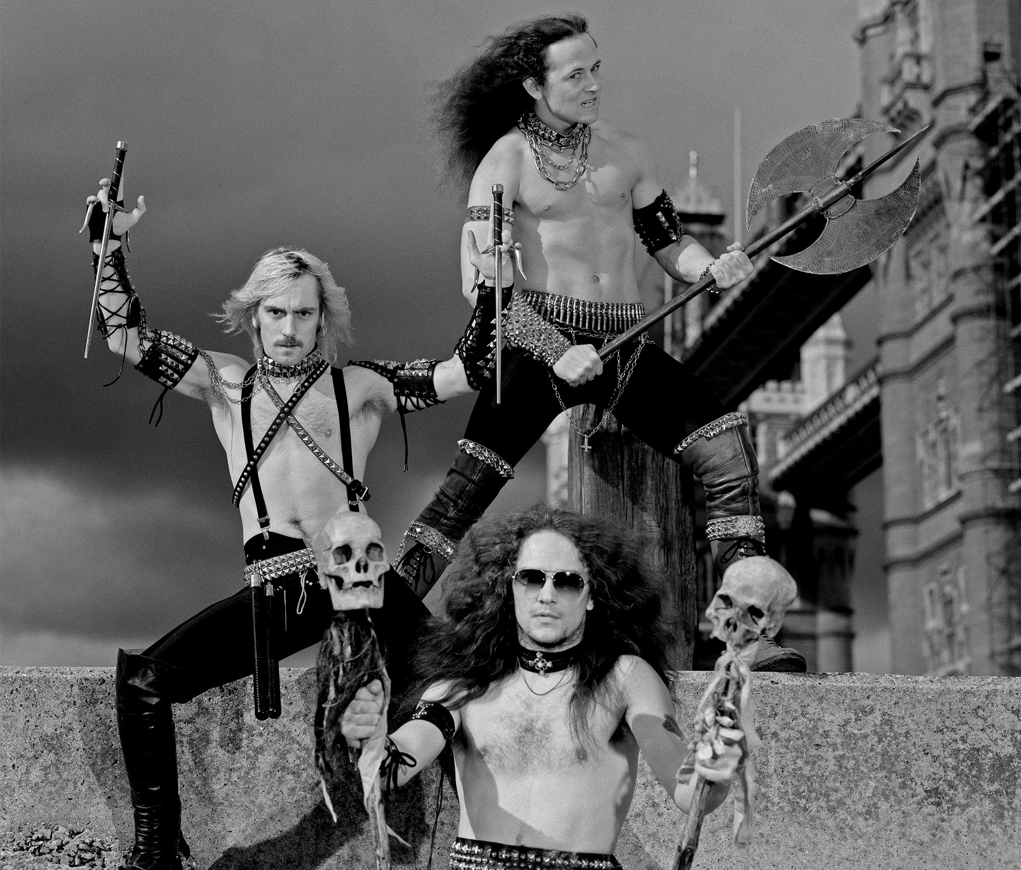 English heavy metal band Venom posed with weapons in front of Tower bridge in London in August 1984. Top to Bottom: bassist Conrad 'Cronos' Lant, guitarist Jeffrey 'Mantas' Dunn and drummer Anthony 'Abaddon' Bray.
