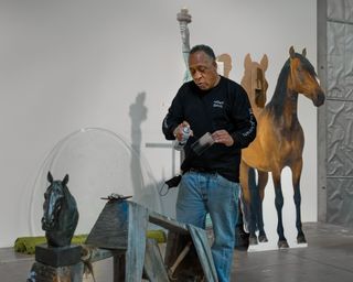Image of artist Henry Taylor at work at Hauser & Wirth Somerset.