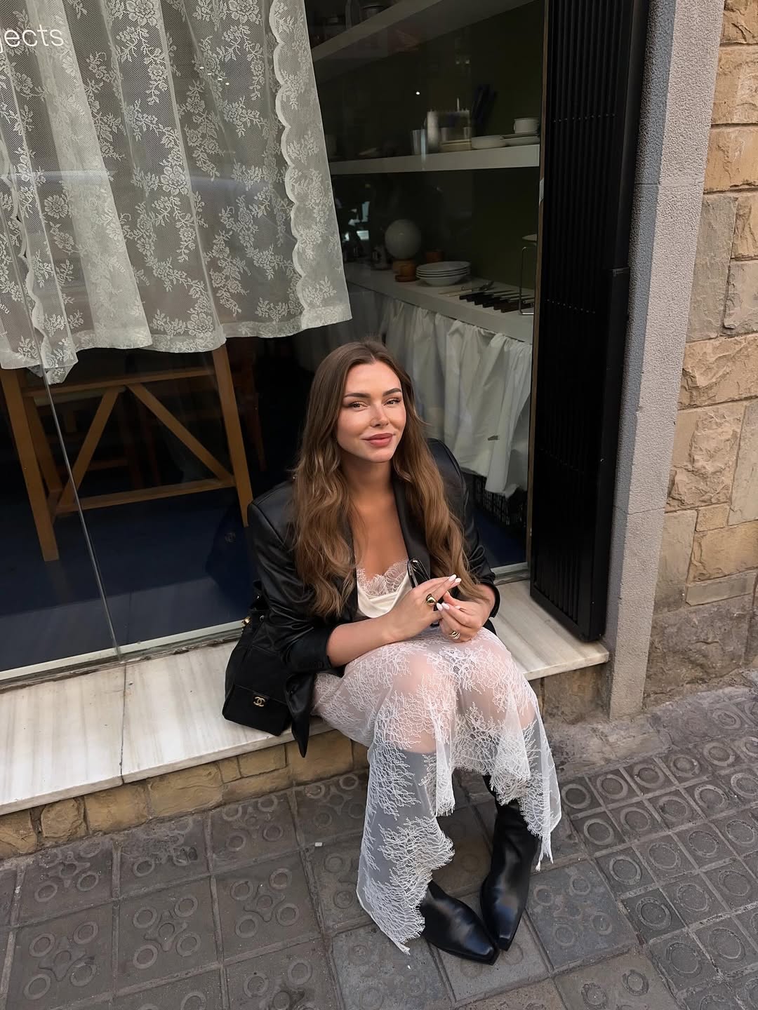 @vivianhoorn wears white lace skirt, black leather jacket, black boots