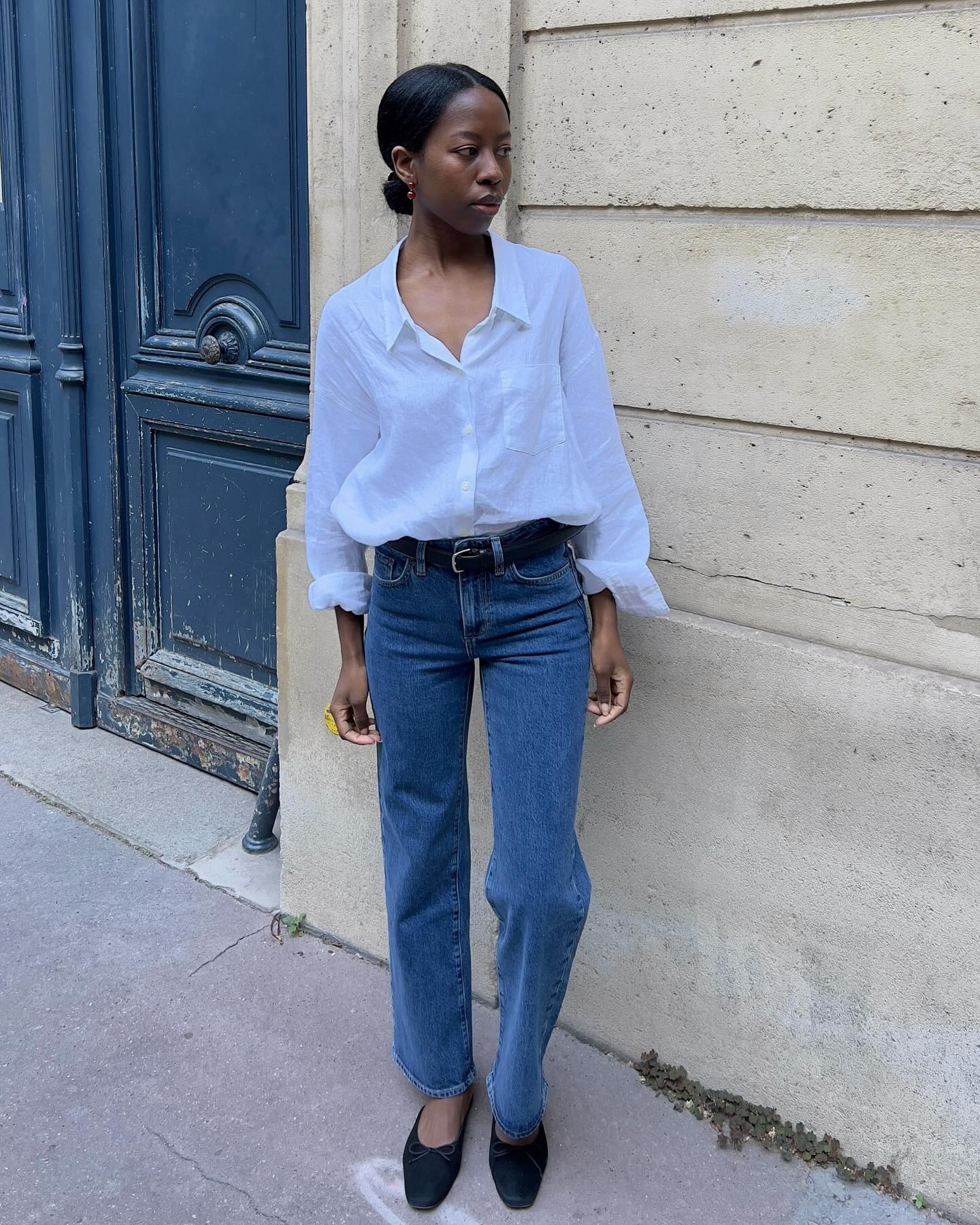 French woman wearing jeans and black flats.