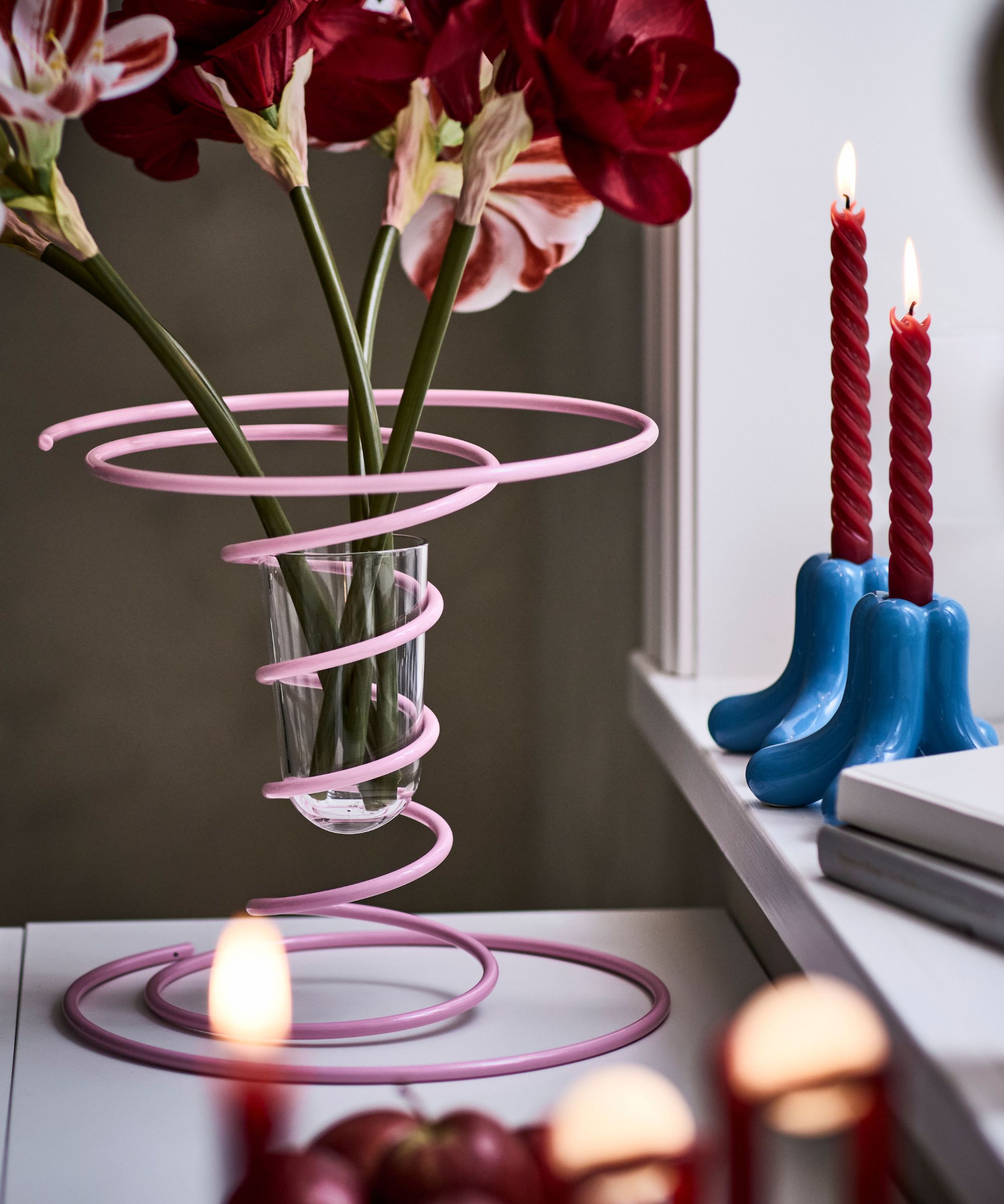 Gustaf Westman x IKEA pink spiral vase holding red flowers