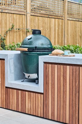 an outdoor kitchen with a green egg grill